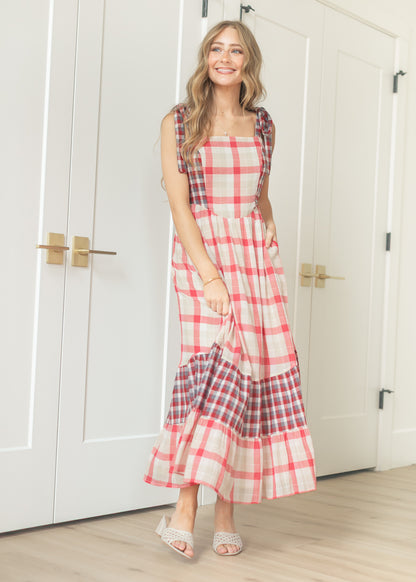 Plaid tie-shoulder maxi dress front view with full tiered skirt and contrast hem