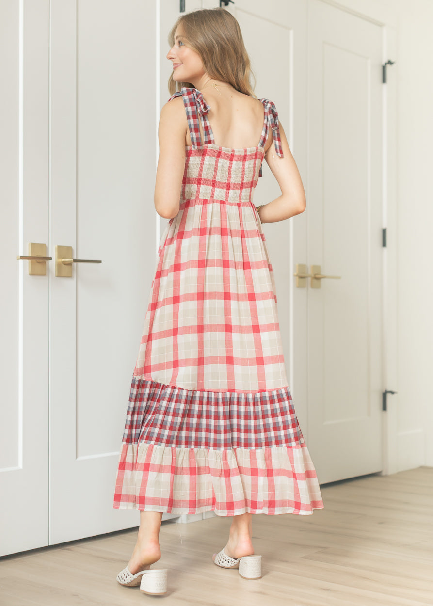 Back view of plaid maxi dress showing smocked back bodice and tiered contrast hem