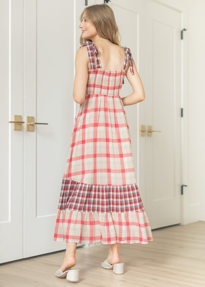 Back view of plaid maxi dress showing smocked back bodice and tiered contrast hem