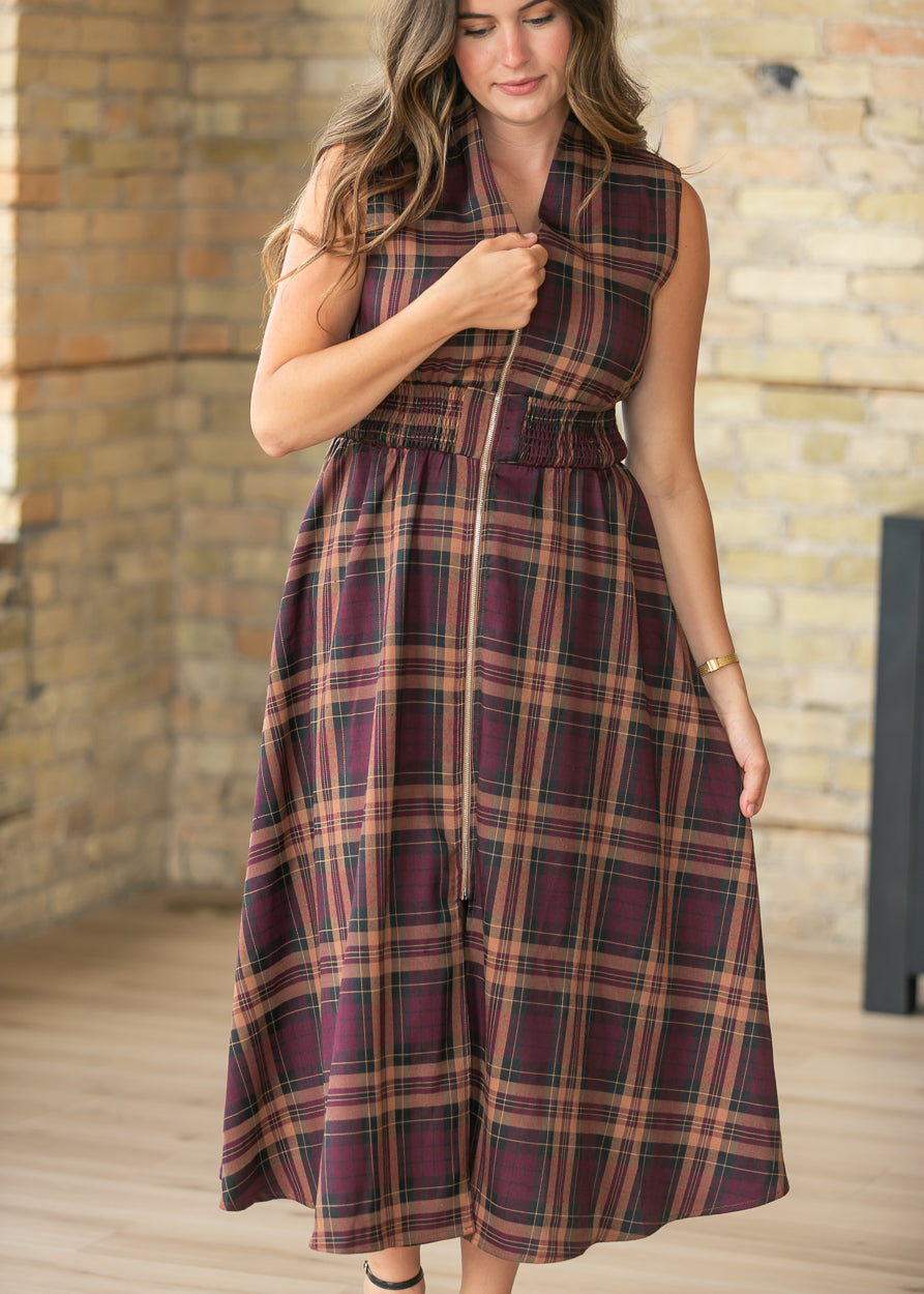 Plaid sleeveless maxi dress with front zipper and side pockets styled for fall.
