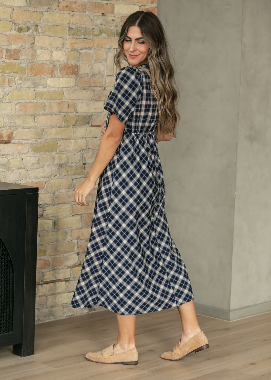 Navy plaid short sleeve midi dress with V-neckline and flowing 47-inch length.
