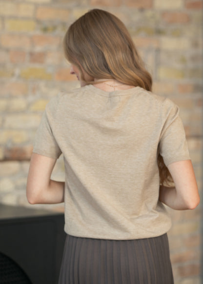 Close-up of the back of the taupe soft touch sweater with short sleeves and a simple crew neckline.
