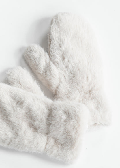 Ivory faux fur mittens styled with a neutral scarf and brown button-front coat.