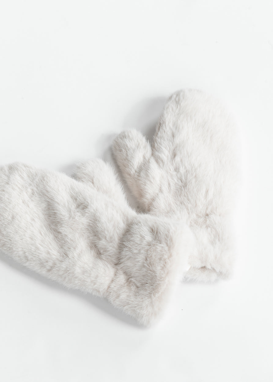 Close-up of plush faux fur mitten showing soft ivory-grey fibers and cozy texture.
