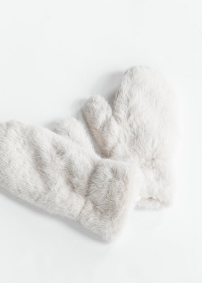Close-up of plush faux fur mitten showing soft ivory-grey fibers and cozy texture.