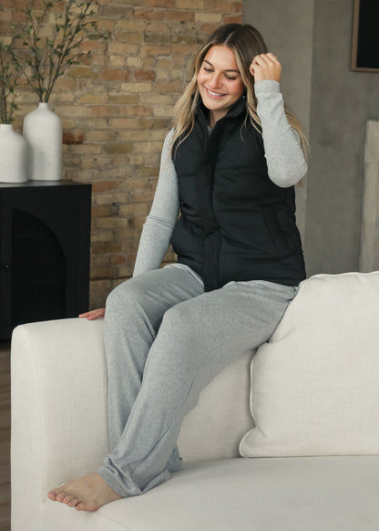 Black Polar short puff vest with zip front and side pockets, layered over an espresso outfit.