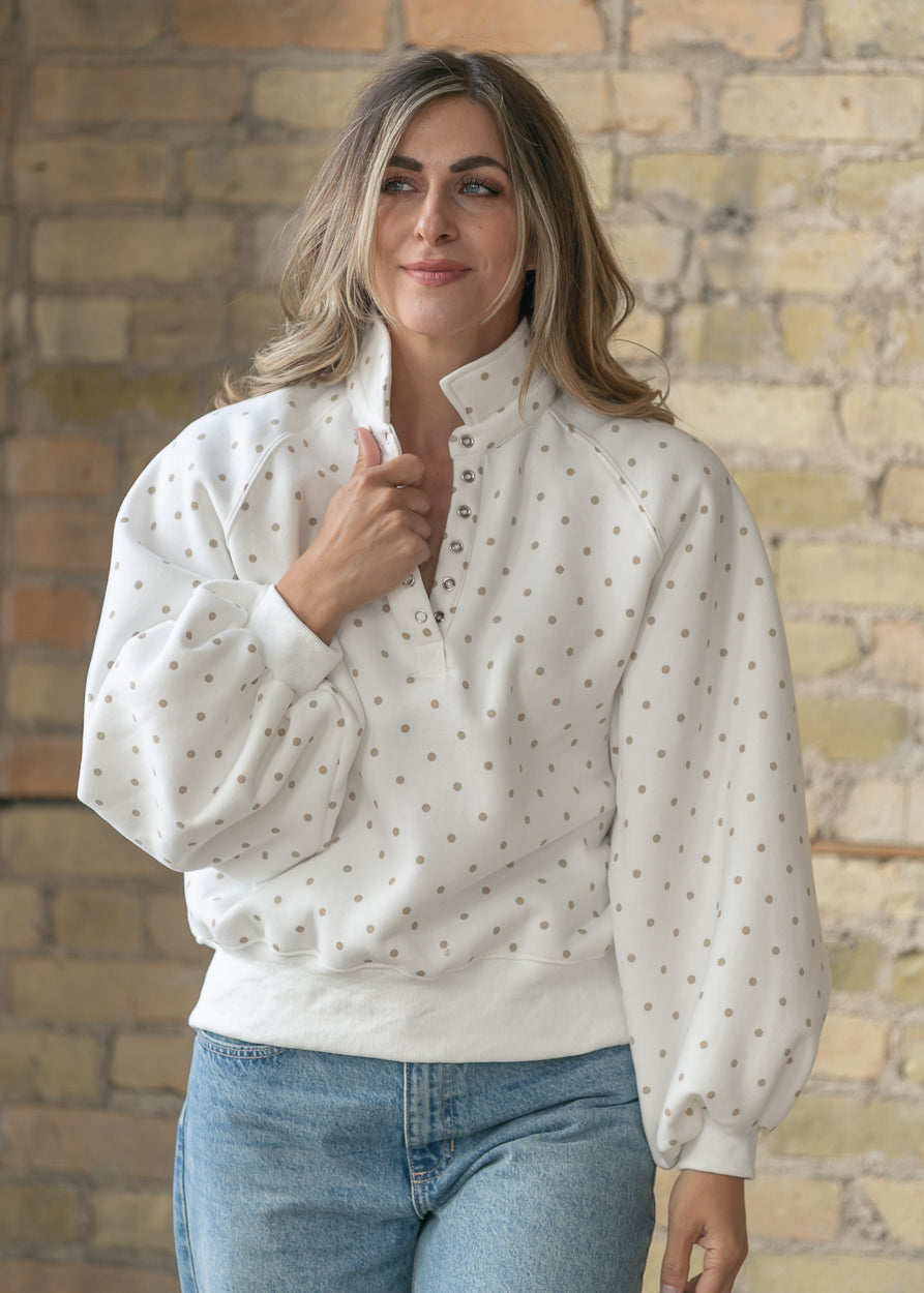 Neutral polka dot oversized pullover with stand collar and casual styling.