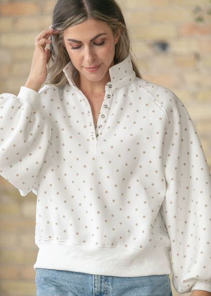 PaperMoon polka dot pullover featuring a stand collar and snap neckline.