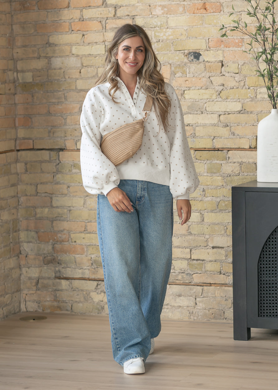 Oversized polka dot sweatshirt styled with relaxed straight leg jeans.