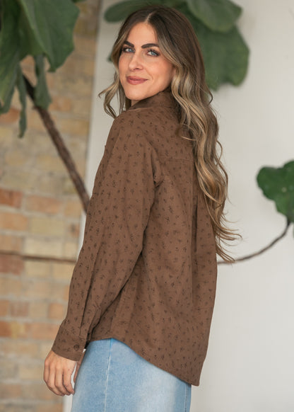 Brown printed corduroy long sleeve shirt styled with a light wash denim maxi skirt and taupe shoes.
