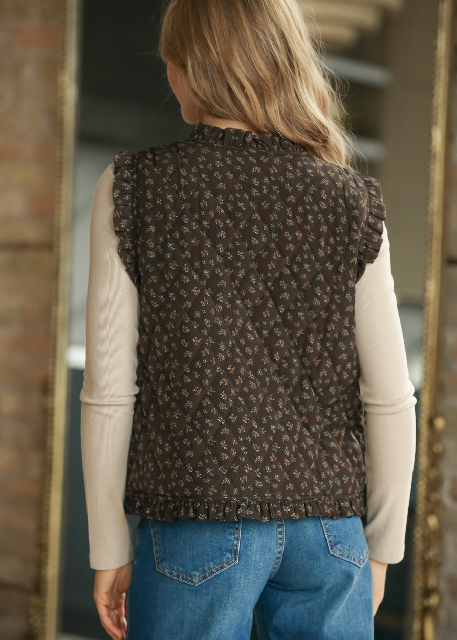 Back view of dark brown floral quilted vest showing sleeveless cut and subtle quilted texture.