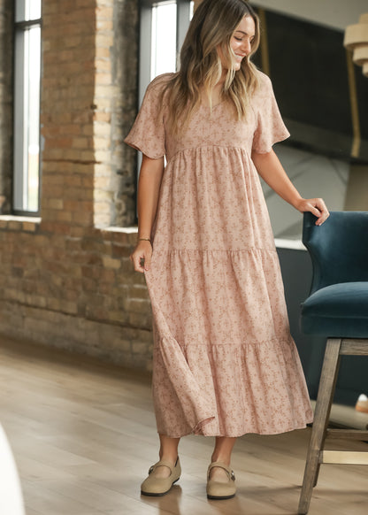 Dusty pink floral maxi dress with sweetheart neckline, flutter sleeves, and gathered bodice.