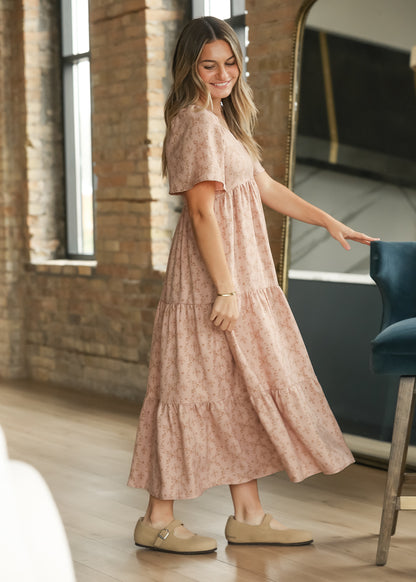 Dusty pink sweetheart neck maxi dress with flowing tiered skirt, styled with neutral flats.