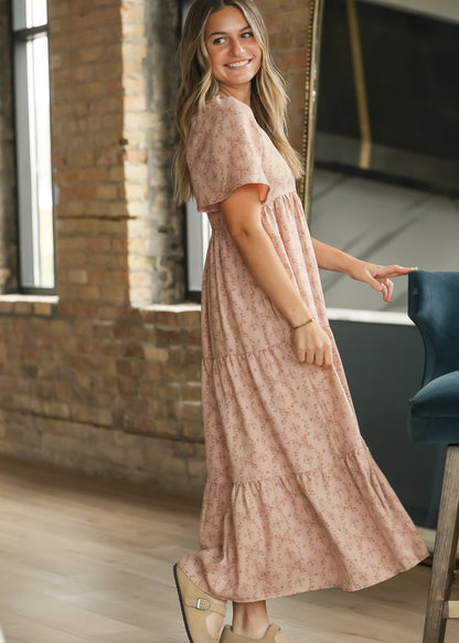 Side view of dusty pink floral maxi dress showing flutter sleeves and loose tiered silhouette.