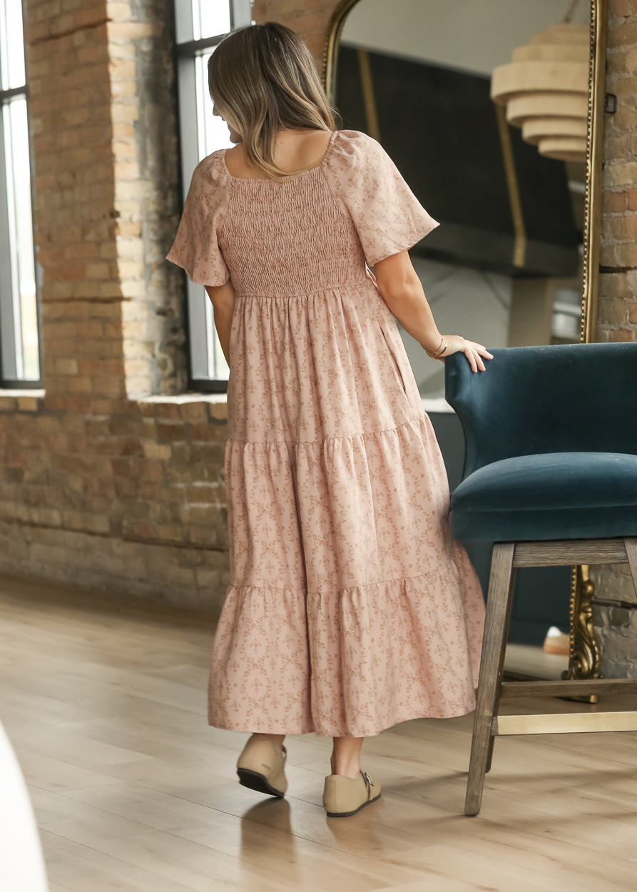 Back of dusty pink maxi dress showing the stretchy smocked bodice and tiered skirt.