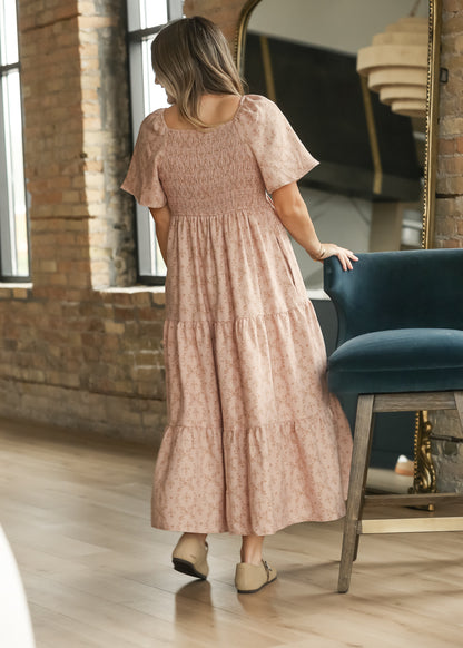 Back of dusty pink maxi dress showing the stretchy smocked bodice and tiered skirt.