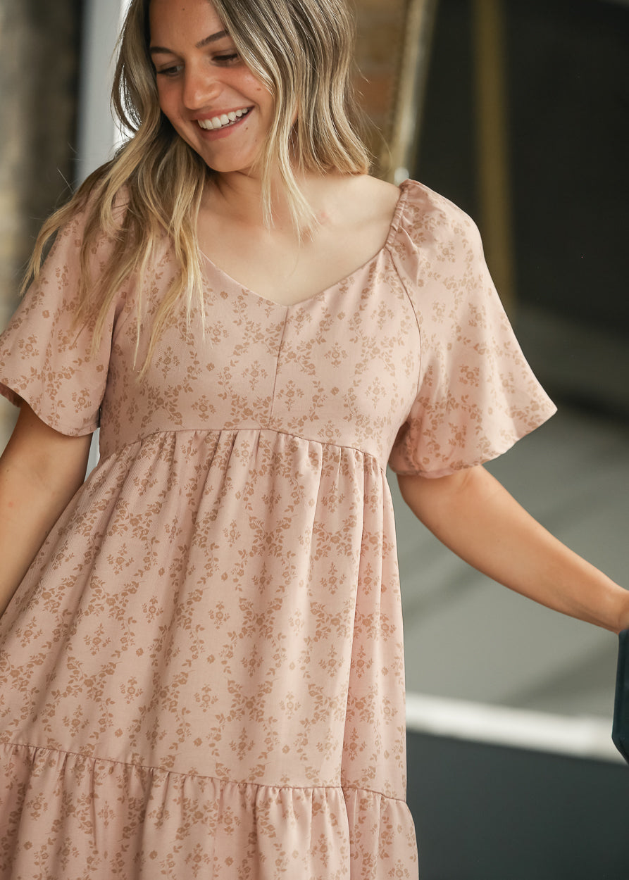 Dusty pink floral maxi dress with sweetheart neckline, flutter sleeves, and gathered bodice.