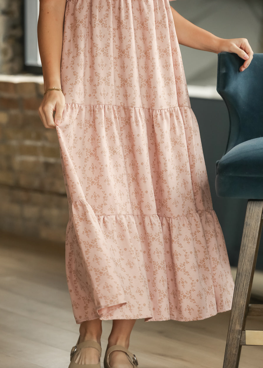 Dusty pink floral maxi dress showing the flowing tiered skirt and tonal floral print.
