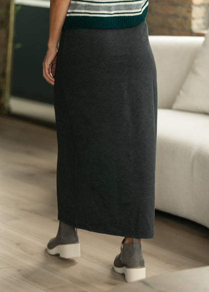 Back view of charcoal gray knit maxi skirt with a clean straight silhouette and stretch waistband.