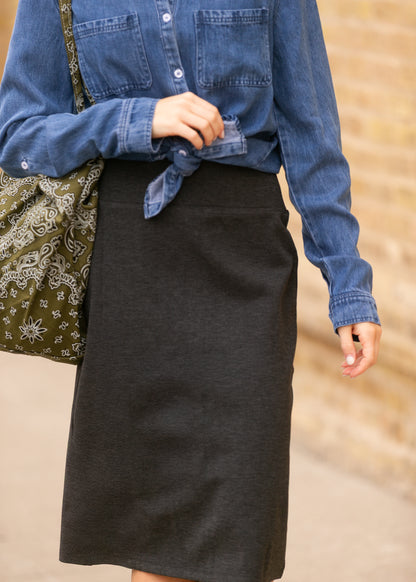Close-up of the thick stretch waistband on the charcoal gray knit midi skirt.