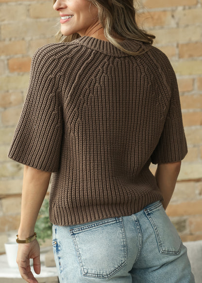 Back of brown raglan crewneck knit top showing ribbed texture and relaxed hip-length fit.