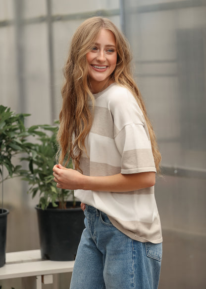 Side view of neutral striped t-shirt with relaxed silhouette