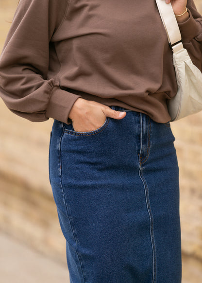 Close-up of Remi dark wash stretch denim showing the front pocket and seam details.