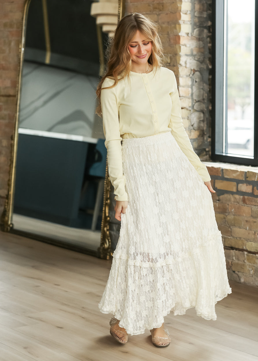 Butter long sleeve ribbed knit top with functional buttons and crew neckline.