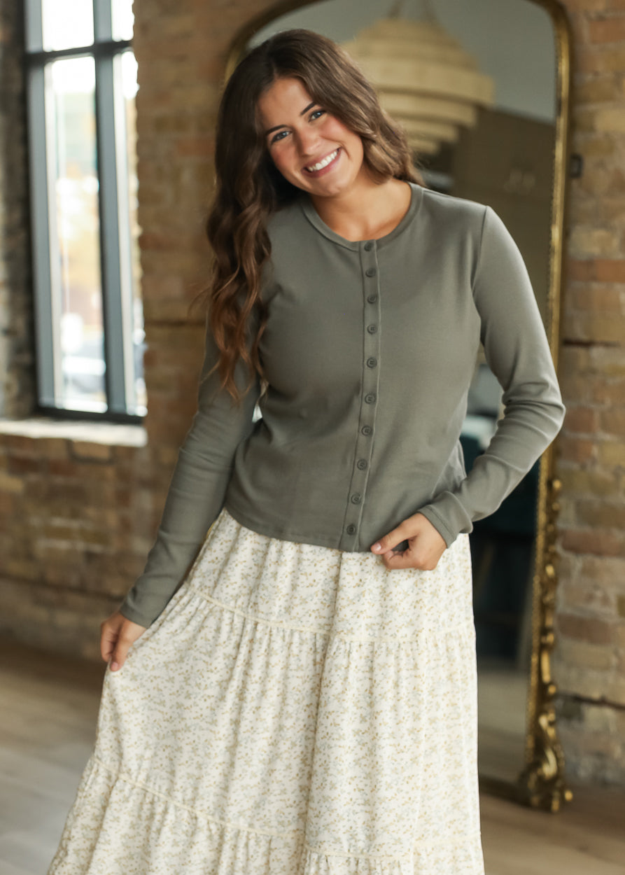 Olive button front knit top paired with a cream floral maxi skirt.