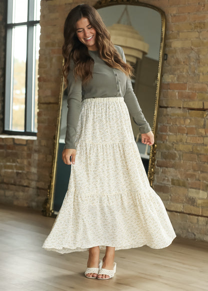 Olive button front knit top paired with a cream floral maxi skirt.