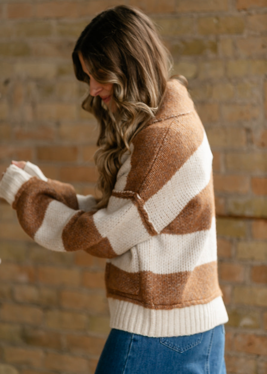 Side view of Saltwater Luxe Cain sweater with loose fit, striped sleeves, and ribbed cuffs.