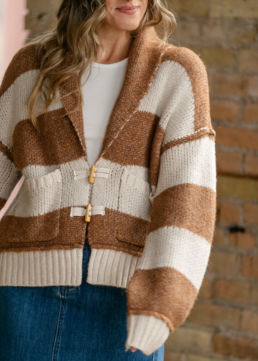 Chestnut and cream striped Cain sweater with shawl collar, toggle closures, and front pockets.