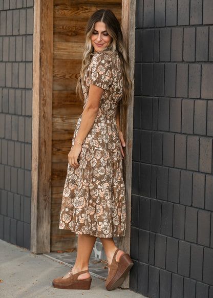 Side view of tiered floral midi dress showing the semi-fitted silhouette and mid-calf length.
