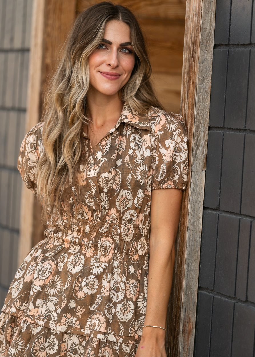 Brown and cream floral midi dress with puffed short sleeves and tiered A-line silhouette.