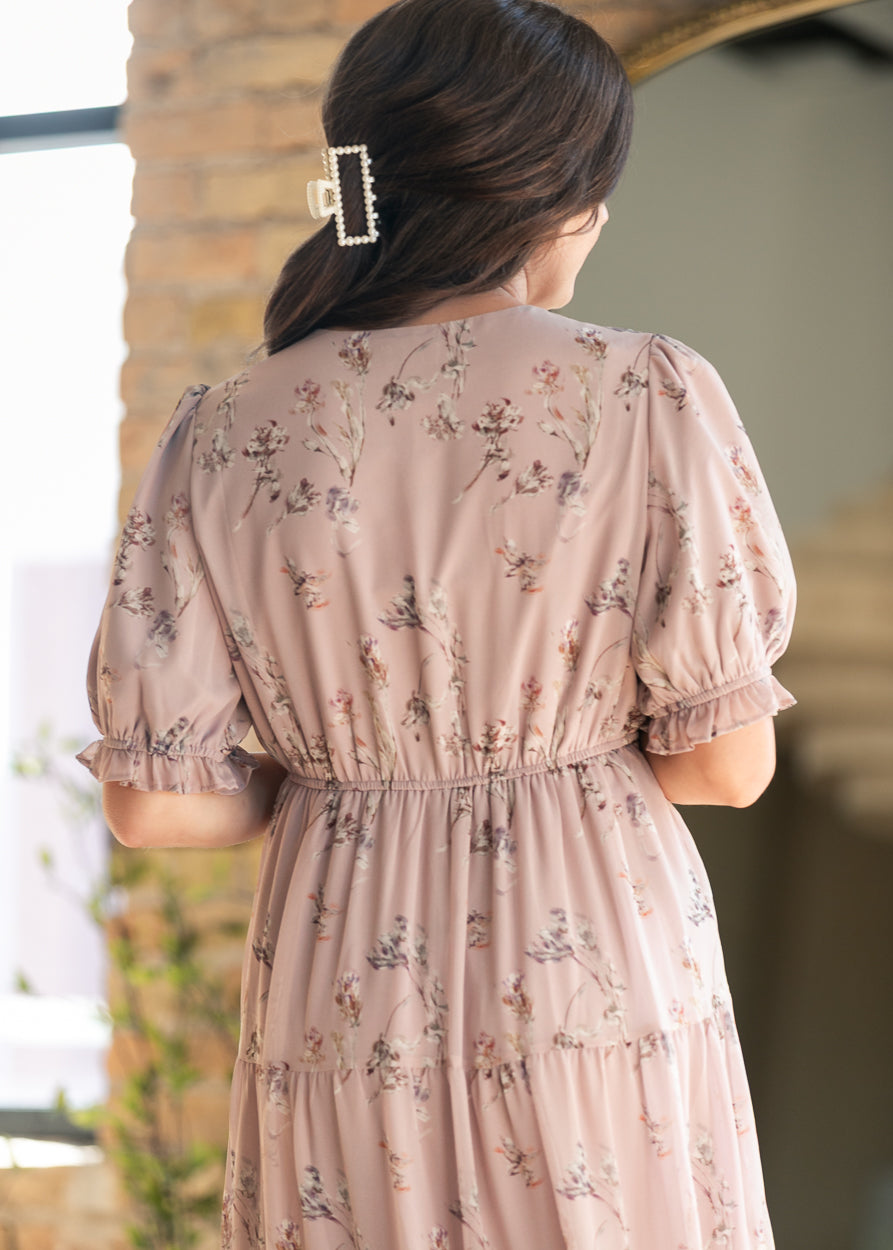 Close-up of blush pink floral maxi dress showing the back neckline, puff sleeves, and gathered waist.
