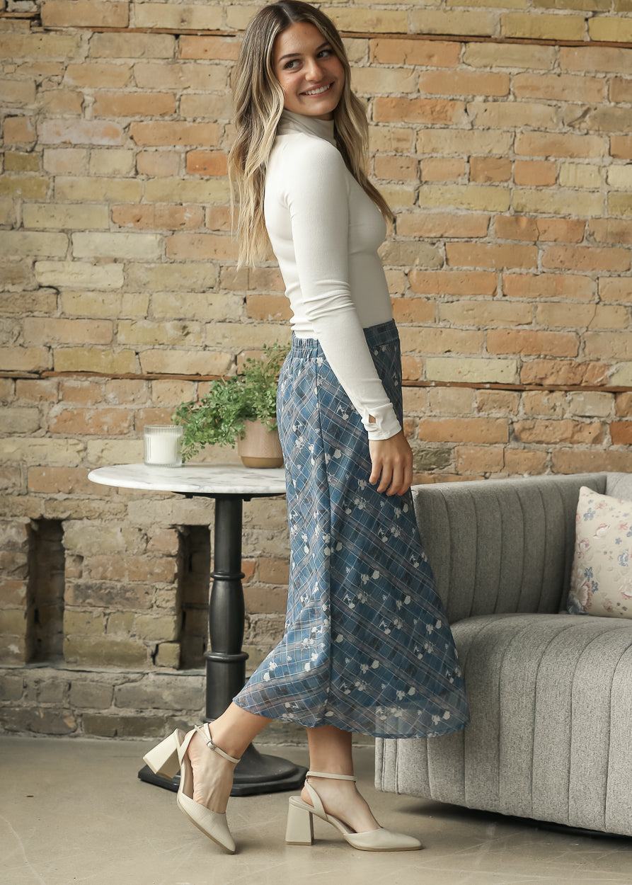 Sadie & Sage Ronan ivory mock neck knit top styled with a blue printed midi skirt.