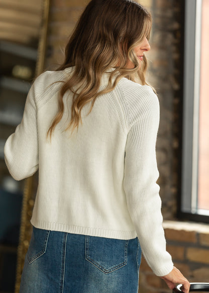 Back view of cream ribbed sweater jacket with hip-length hem