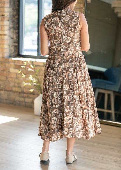 Back view of sleeveless floral midi dress showing the gathered waist and mid-calf length.
