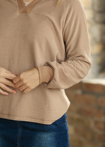 Close-up of striped sleeve showing the gathered cuff and contrast ribbed wrist trim.