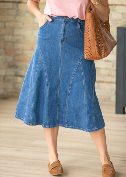 Medium wash denim midi skirt with stitch detail panels and front pockets styled with a pink blouse.