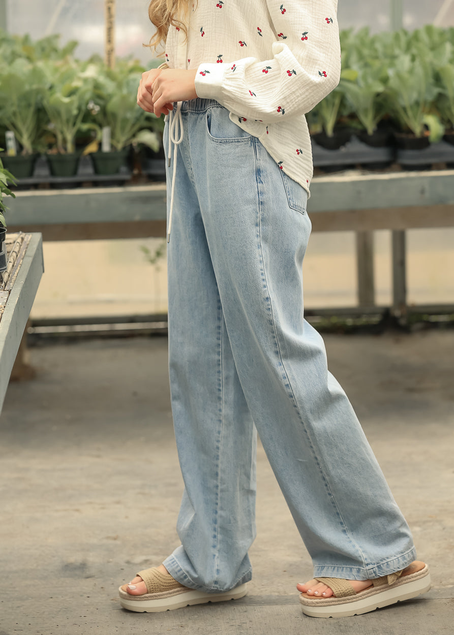 Relaxed straight leg drawstring jeans styled with a cherry print blouse
