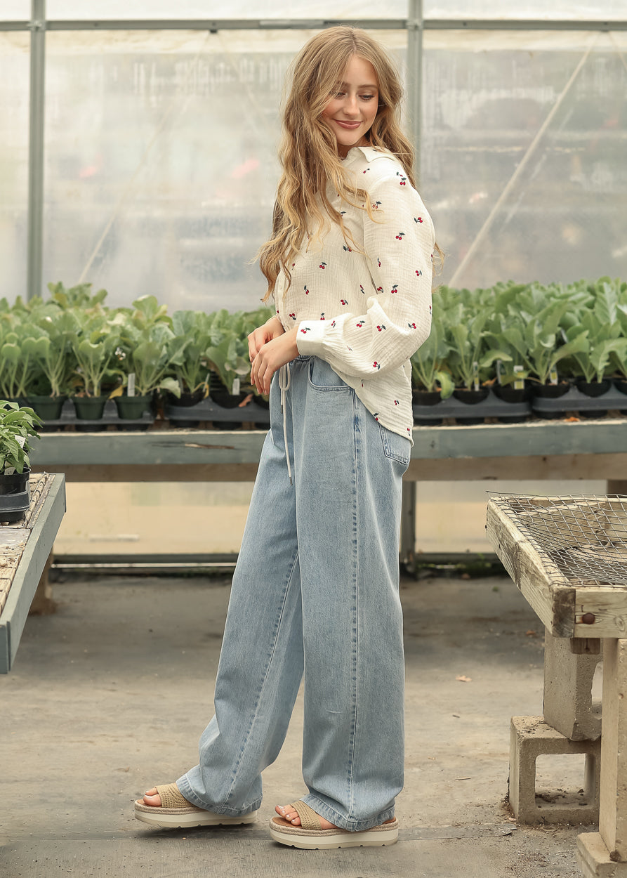 Straight leg drawstring jeans paired with a lightweight blouse