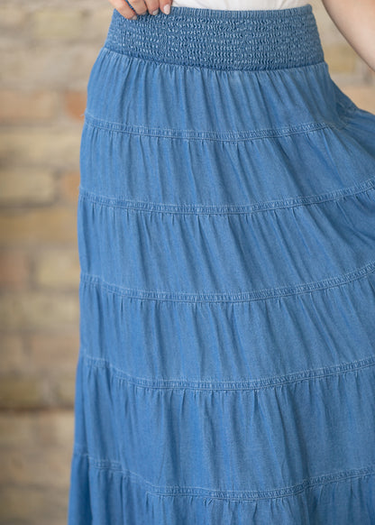 Close view of smocked elastic waistband on blue chambray maxi skirt