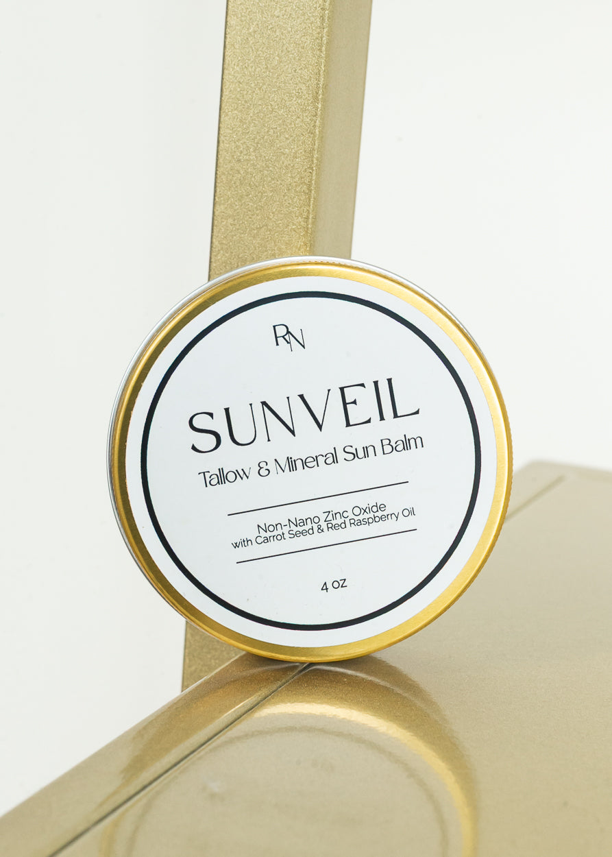 Tallow and mineral sun barrier balm in a gold metal tin with clean white label.