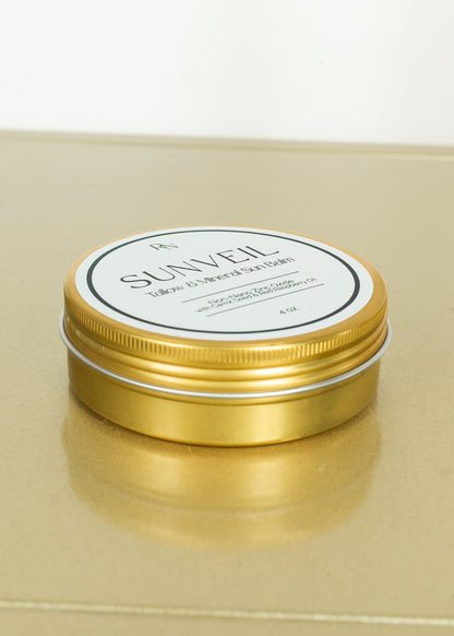 SunVeil tallow and mineral sun balm displayed in gold tin packaging.