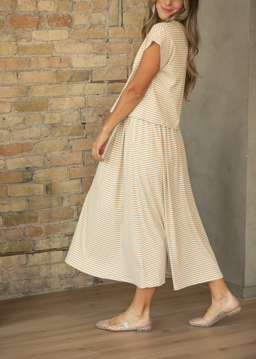 Taupe stripe rib knit midi skirt in motion, styled with the coordinating striped top and clear flats.