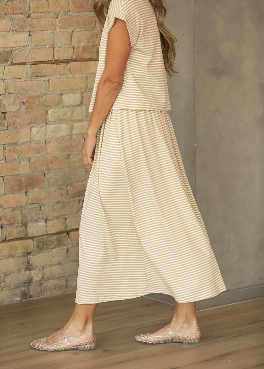 Side view of taupe stripe rib knit midi skirt showing the loose, flowing silhouette and ankle-skimming hem.