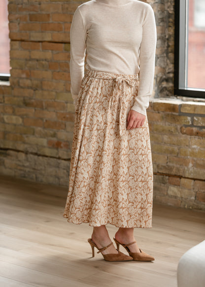 Taupe and cream floral midi skirt styled with a lightweight cream turtleneck and heels.