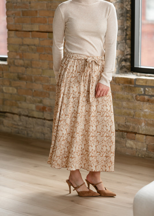 Taupe and cream floral midi skirt styled with a lightweight cream turtleneck and heels.