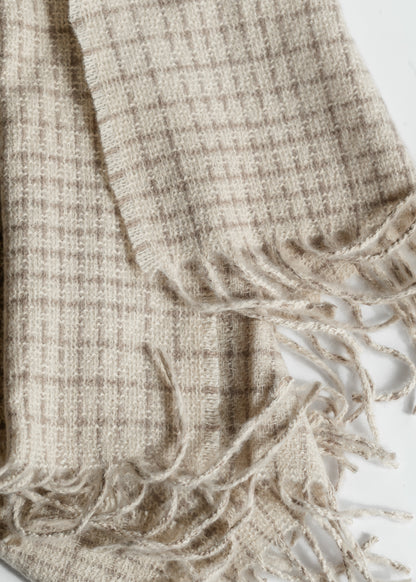Close-up of ivory and taupe woven check pattern with soft brushed texture and twisted fringe.